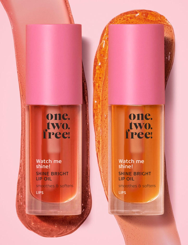 Two products of shine bright oil on a pink background